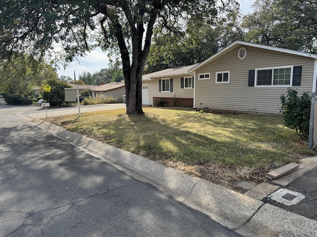 ranch-style home with a front lawn