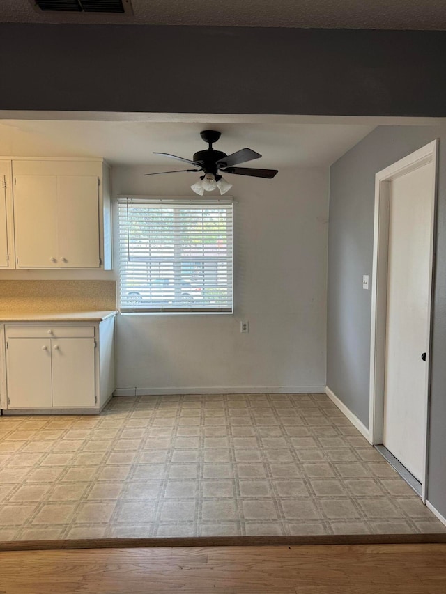 interior space with ceiling fan