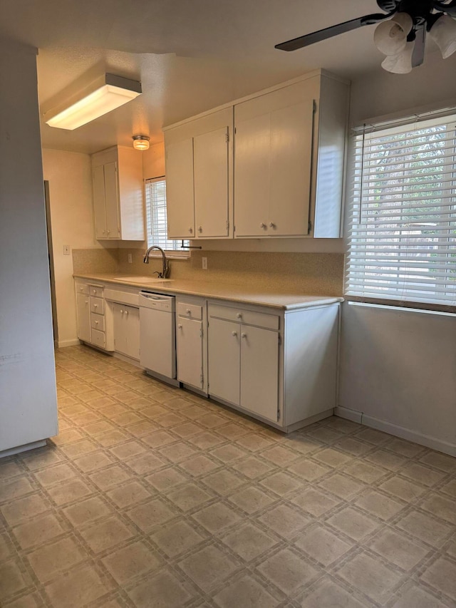 kitchen with dishwasher, white cabinetry, sink, and ceiling fan