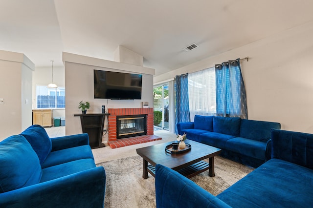 living room with carpet, vaulted ceiling, and a fireplace