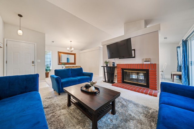 living room with a brick fireplace, a notable chandelier, and carpet