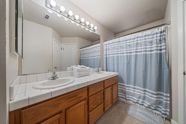 bathroom featuring walk in shower and vanity