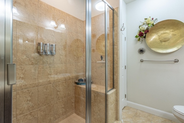 bathroom featuring tile patterned floors, toilet, and an enclosed shower