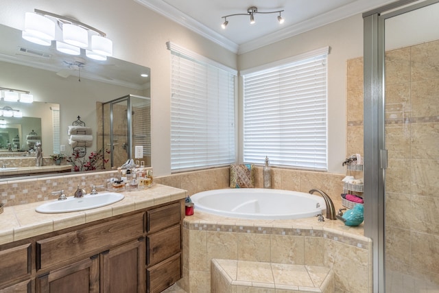 bathroom featuring plus walk in shower, vanity, and ornamental molding