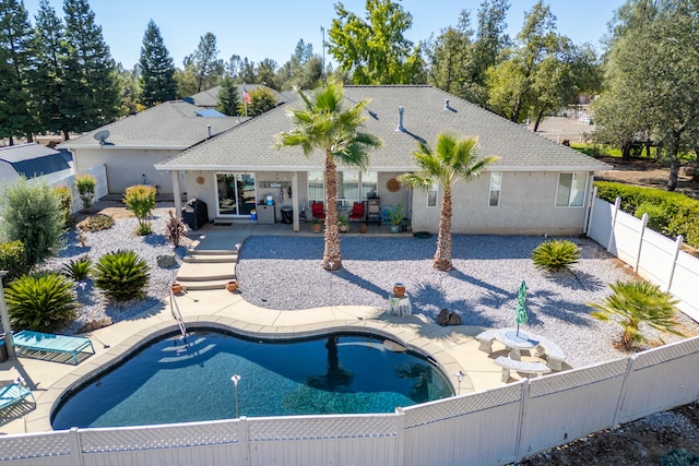 view of pool featuring a patio and a grill