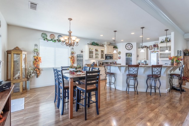 dining area featuring a chandelier and light hardwood / wood-style flooring