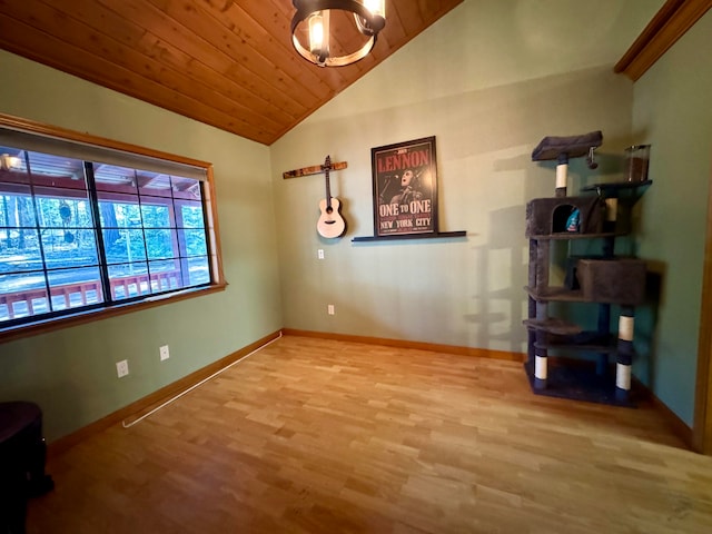 spare room with wood-type flooring, vaulted ceiling, and wooden ceiling