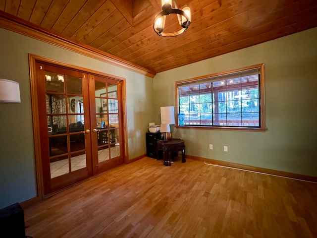 spare room with wood-type flooring, wood ceiling, ornamental molding, and french doors