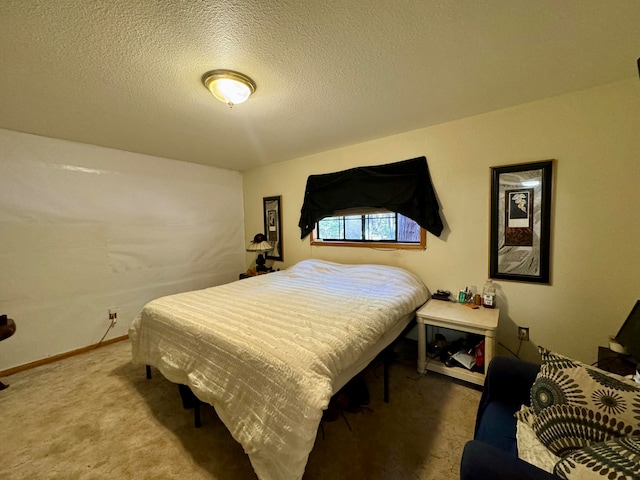 bedroom featuring carpet and a textured ceiling