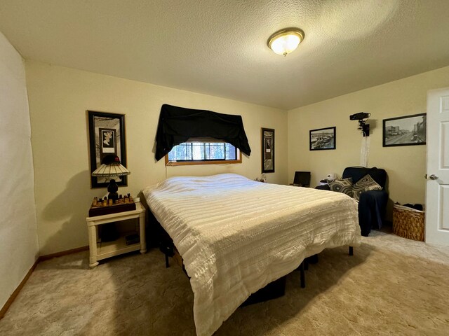 bedroom featuring a textured ceiling and carpet