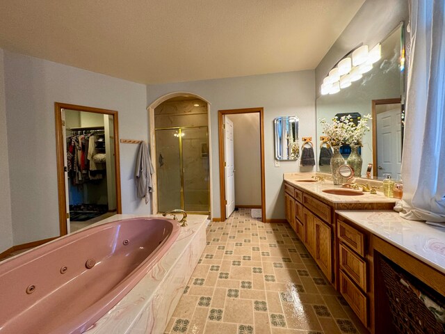 bathroom with independent shower and bath and vanity