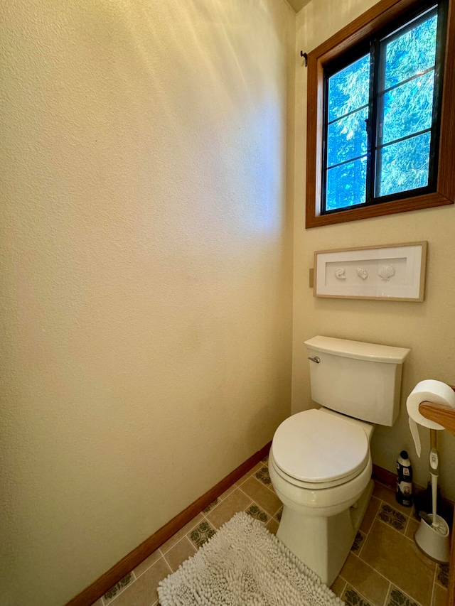 bathroom with toilet and tile patterned floors