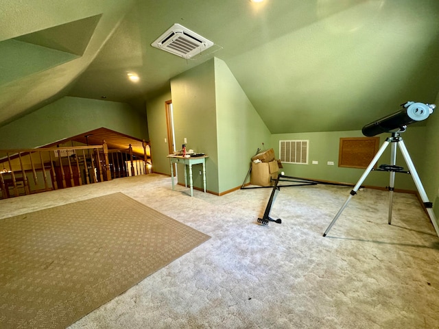 additional living space with carpet floors and vaulted ceiling