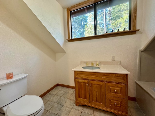 bathroom featuring tile patterned flooring, vanity, and toilet