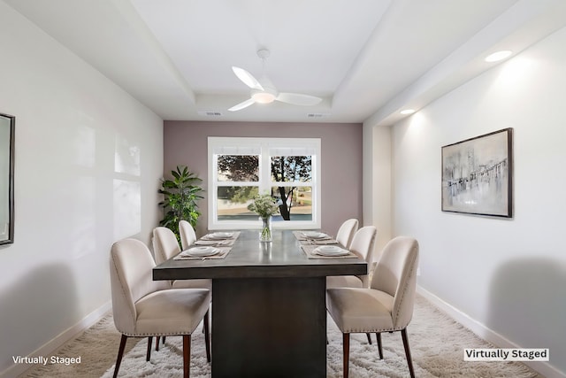 dining space featuring carpet floors and ceiling fan