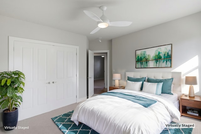 bedroom with ceiling fan, a closet, and carpet