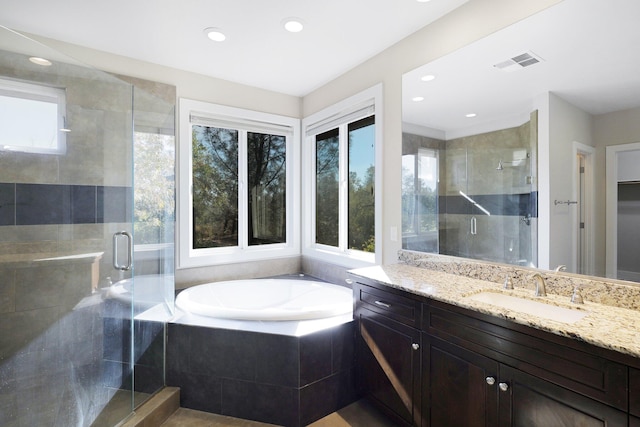 bathroom featuring vanity and plus walk in shower