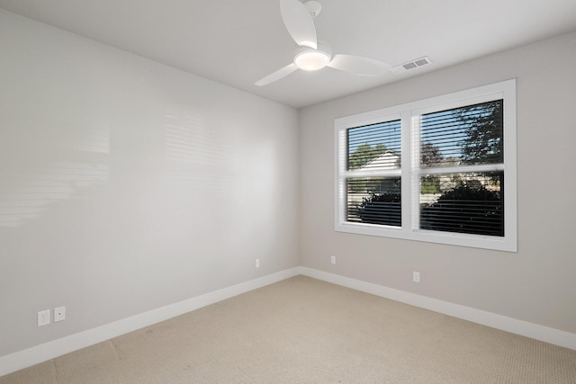 empty room with ceiling fan and carpet