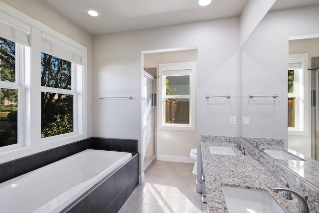 full bathroom with plus walk in shower, vanity, a healthy amount of sunlight, and toilet