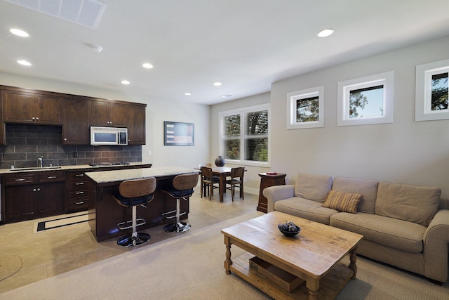 living room featuring light tile patterned floors and sink