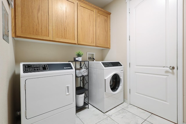 laundry room featuring cabinets and washing machine and dryer