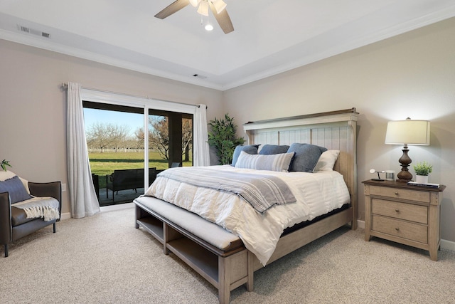 carpeted bedroom with a raised ceiling, access to exterior, ceiling fan, and crown molding