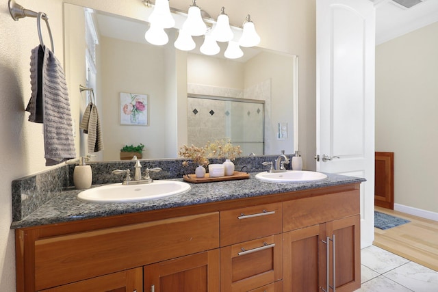 bathroom with vanity and a shower with door