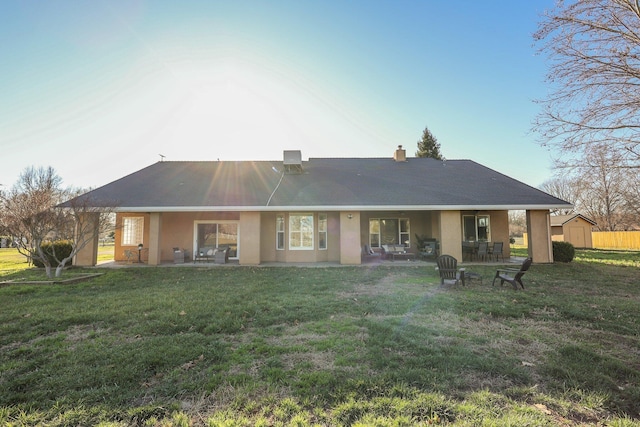 rear view of property featuring a yard and a patio