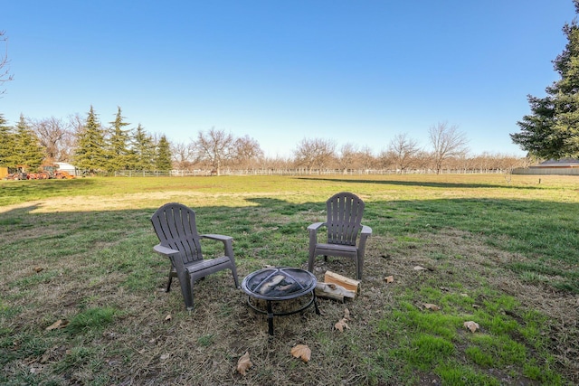 view of yard with a rural view and a fire pit