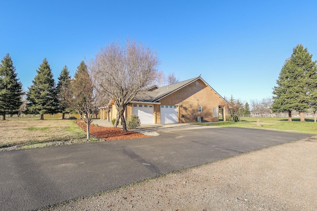 exterior space featuring a yard and a garage