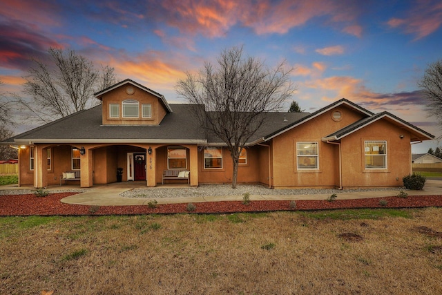 view of front of property featuring a lawn and a porch