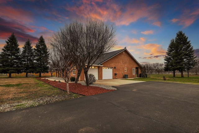 view of front of home with a yard and a garage