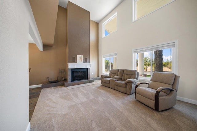 carpeted living room featuring a towering ceiling