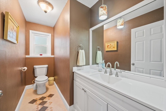 bathroom with vanity, tile patterned flooring, and toilet