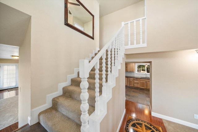 stairway featuring wood-type flooring and sink