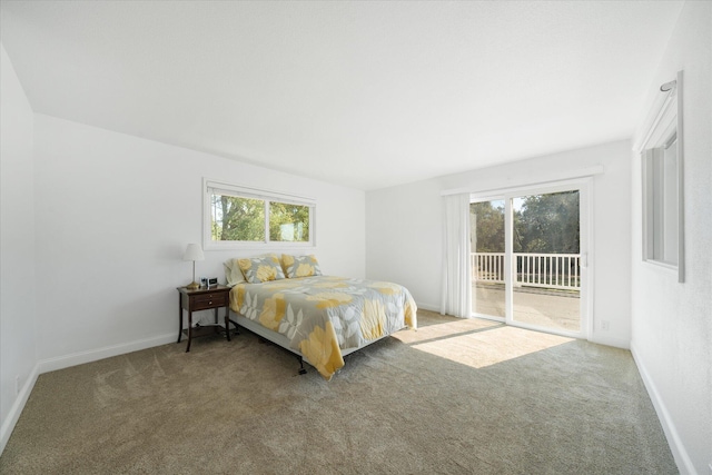 bedroom with carpet flooring, multiple windows, and access to outside