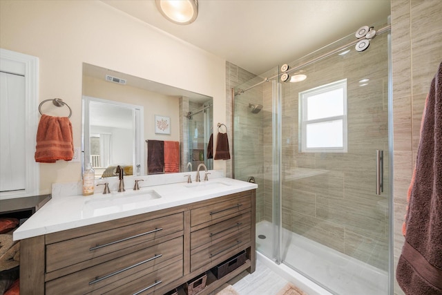 bathroom featuring vanity and an enclosed shower