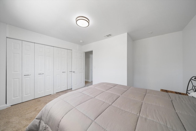 carpeted bedroom with a closet