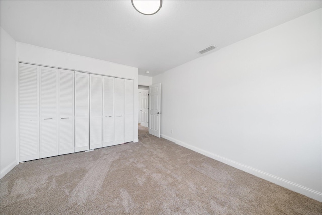 unfurnished bedroom with light colored carpet