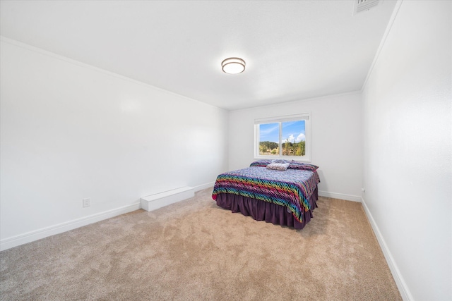 carpeted bedroom featuring crown molding