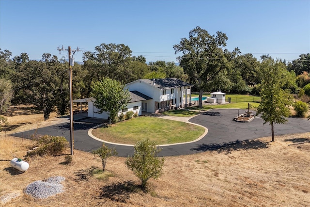 exterior space featuring a front yard and a fire pit