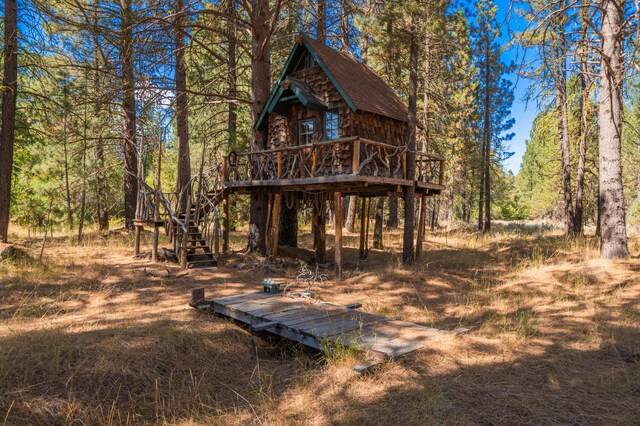 rear view of property with a wooden deck