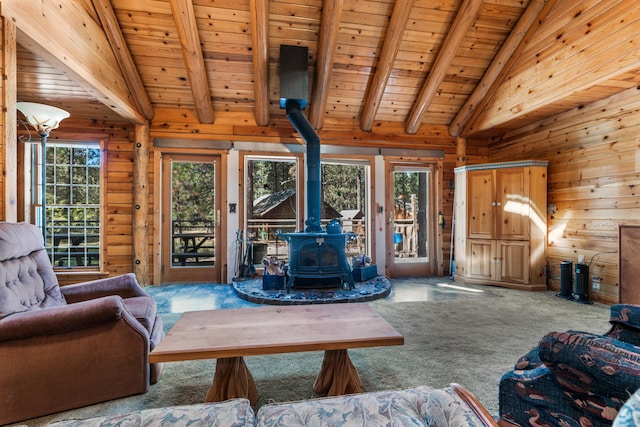 carpeted living room with lofted ceiling with beams, a wood stove, and wooden ceiling