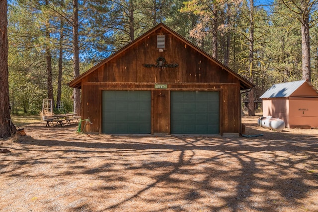 garage featuring wood walls