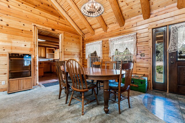 carpeted dining room with wooden ceiling, wooden walls, beam ceiling, and a notable chandelier