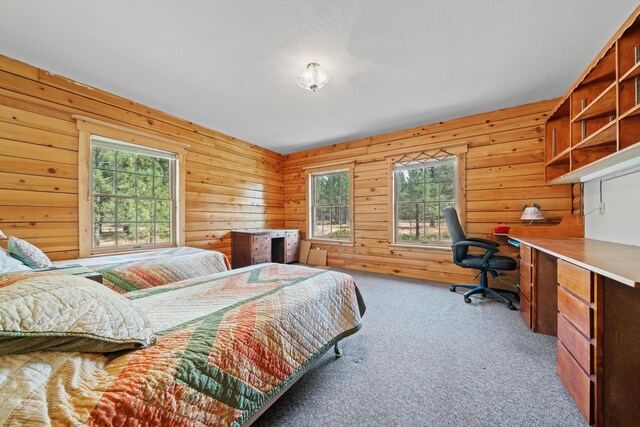 bedroom with wooden walls and light carpet