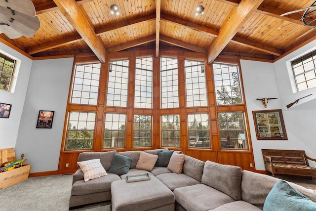 carpeted living room featuring wood ceiling, ceiling fan, and a healthy amount of sunlight