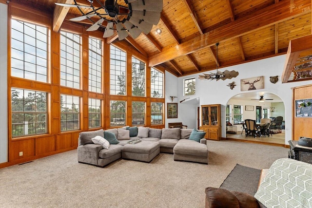 living room featuring ceiling fan, high vaulted ceiling, and a healthy amount of sunlight