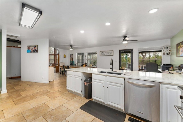 kitchen featuring dishwasher, ceiling fan, white cabinetry, and sink