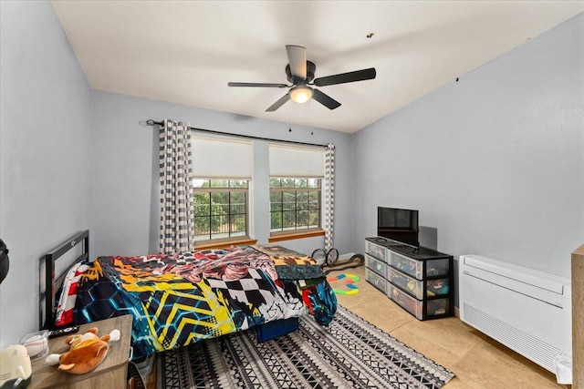 tiled bedroom featuring ceiling fan